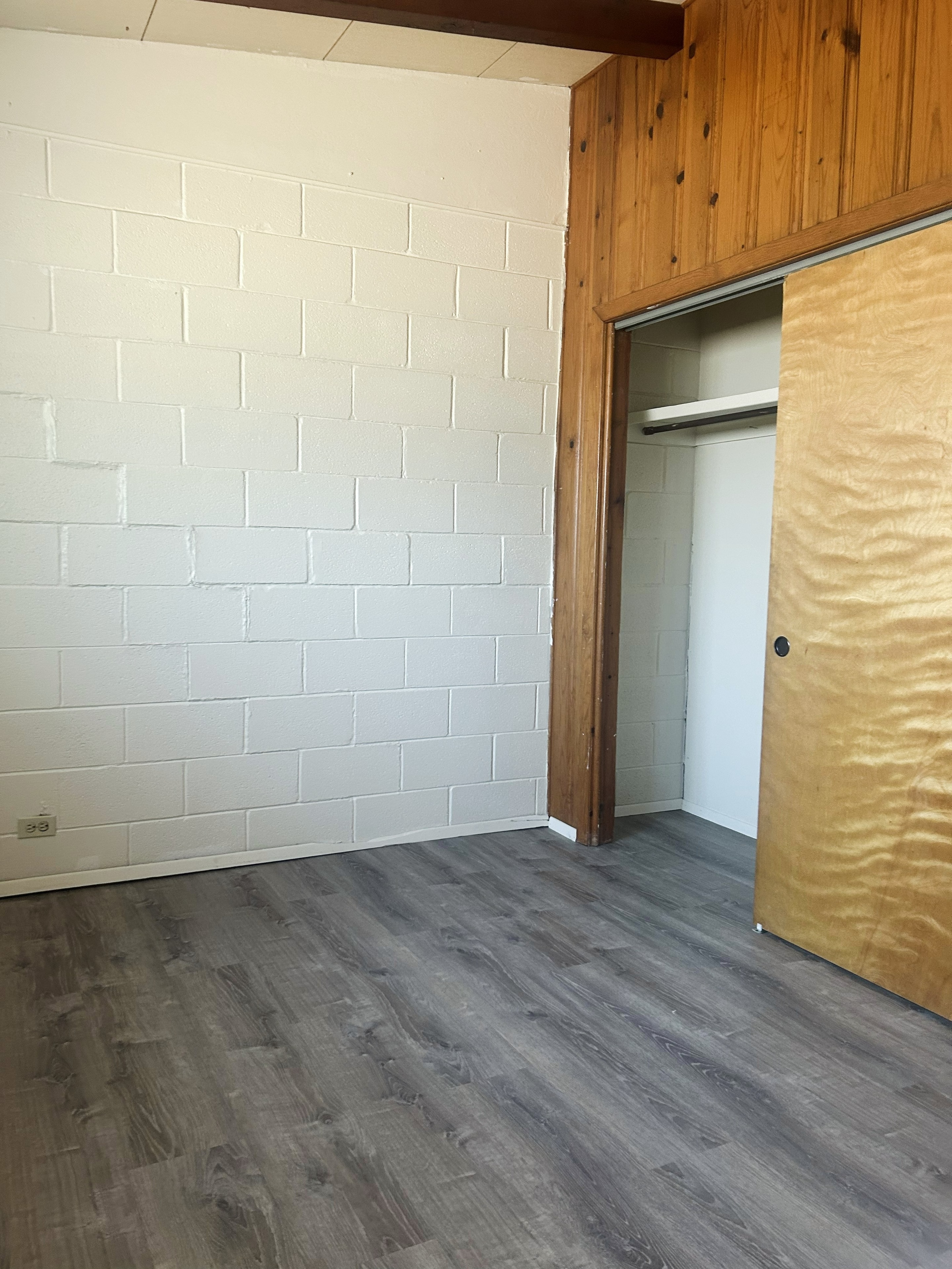 705 Bursum bedroom with cinder block wall, wood trim and closet