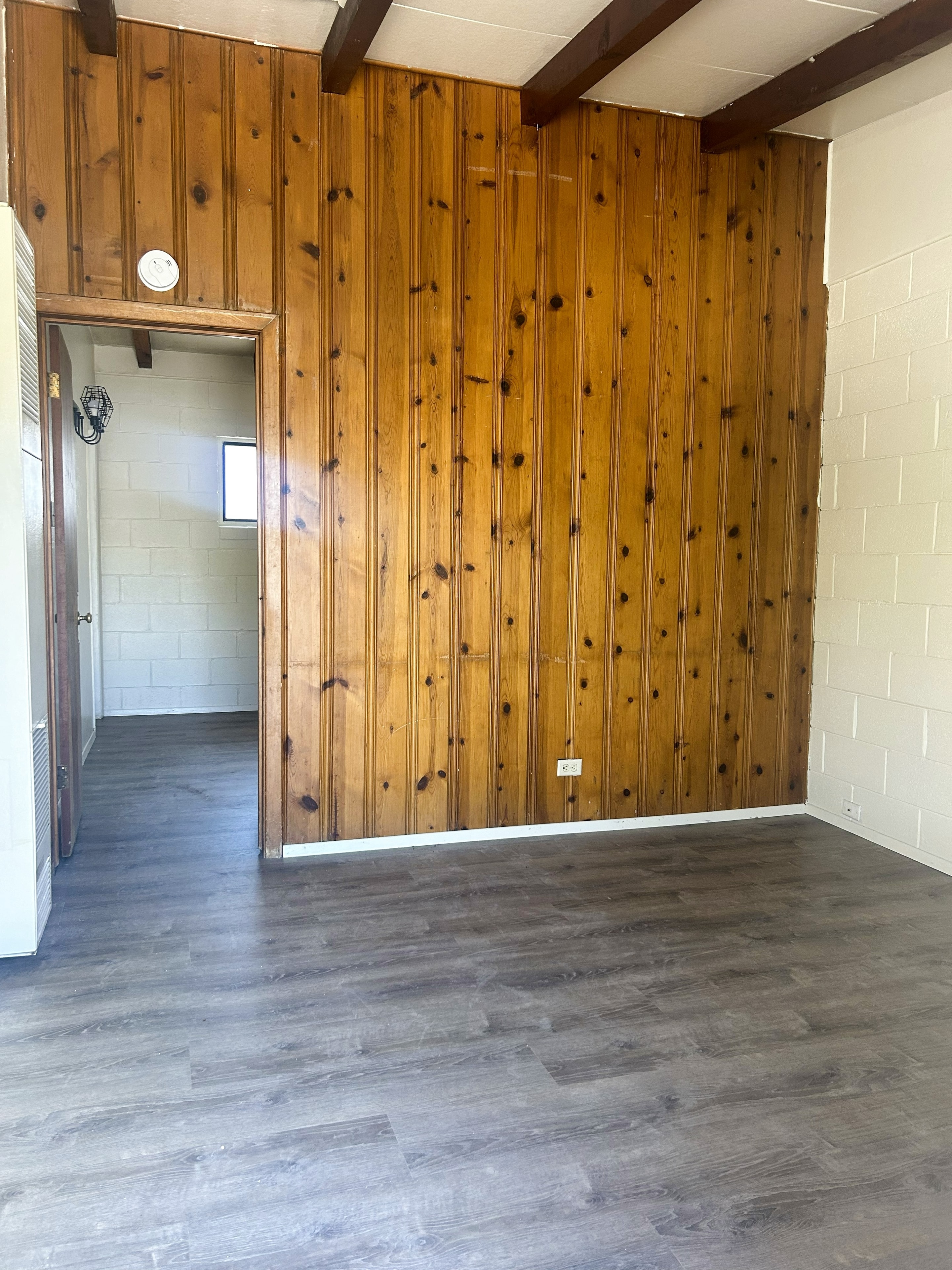705 Bursum living room with wood-paneled wall and vinyl plank flooring